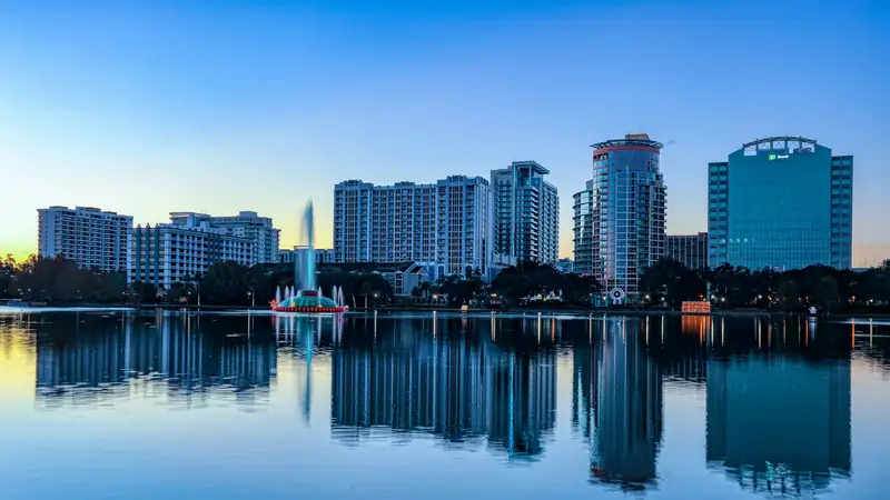 Downtown Orlando office and residential towers reflected in Lake Eola at sunrise