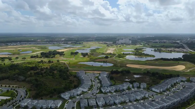 Aerial view of tile roofed homes, a golf course and lakes in inland Central Florida near Four Corners