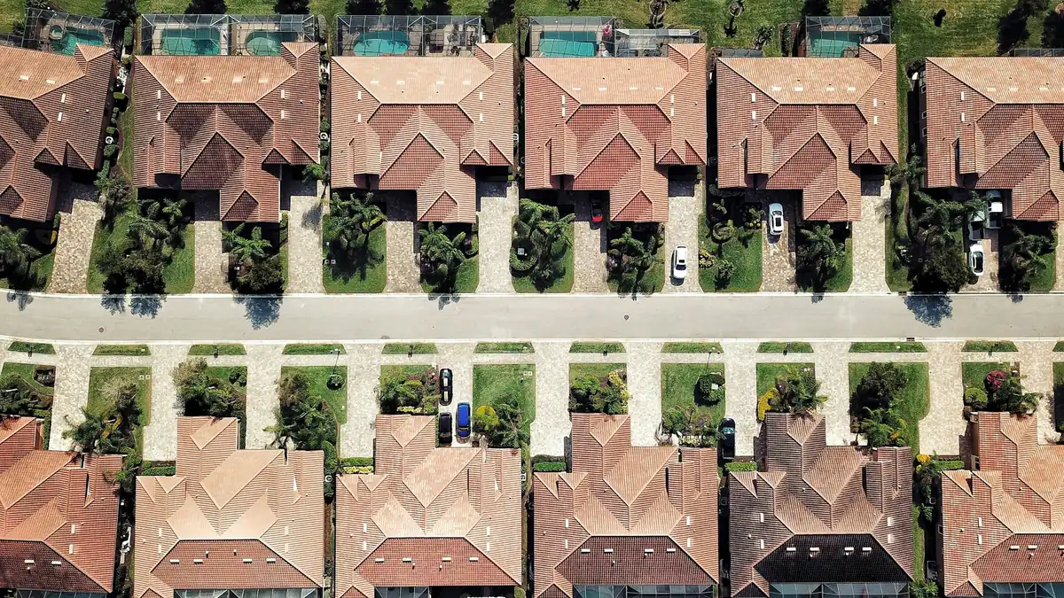 Overhead view of two rows of tile hip roofs on a Florida residential street
